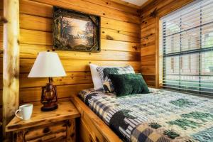 a bedroom with a bed in a log cabin at Joy's Retreat Cabin in Sevierville +45 photos