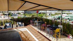a patio with tables and chairs under a tent at Hotel NEXT Guadalajara in Guadalajara