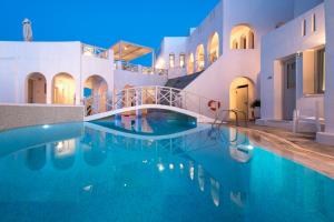 a swimming pool with a bridge in a building at Kanale's Rooms & Suites in Naousa