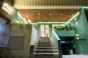 a staircase leading to a building with plants on it at NiK Hotel Nguyen Trai in Ho Chi Minh City