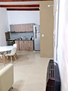 a kitchen with a table and a refrigerator at Viedma in Viedma