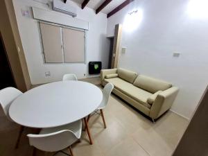a living room with a couch and a table and chairs at Viedma in Viedma