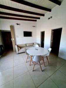 a living room with a table and chairs and a couch at Viedma in Viedma