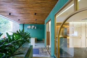 a room with green walls and a wooden ceiling at NiK Hotel Nguyen Trai in Ho Chi Minh City +47 photos