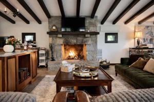 a living room with a fireplace and a couch at Honeymoon Cottage Chateau DuMont in Banner Elk