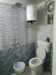 a bathroom with a toilet and a sink at Urban Cozy 2 bhk in Ghaziabad +26 photos