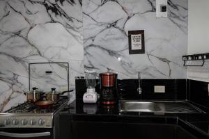 a kitchen with a counter with a blender and a stove at San Cristóbal Surf House II in San Cristóbal +14 photos