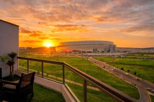 a view of a football stadium at sunset from a balcony at City & Stadium Luxe - Tangier in Tangier