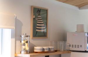 a kitchen with a picture of a cat on the wall at Mangapiko Cabin in Pirongia +12 photos