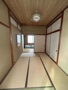 an empty room with a ceiling at Toolate Guesthouse Toyama in Toyama