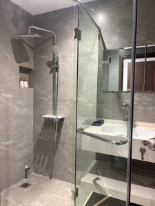 a bathroom with a glass shower and a sink at ASEAN MINH NGUYỆT Hotel in Nhân Mỹ +27 photos