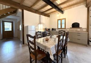 a kitchen and dining room with a table and chairs at Lo casalar in Noguères