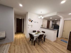 a dining room and kitchen with a table and chairs at Hann's Residence Your second home in Sibu