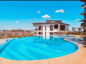 a large swimming pool in front of a building at Hann's Residence Your second home in Sibu