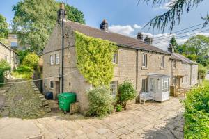 an old brick house with ivy on the side of it at 5 Bed in Wath oc-w28415 in Wath