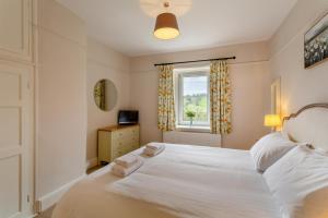 a bedroom with a white bed and a window at 5 Bed in Wath oc-w28415 in Wath