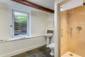 a bathroom with a shower and a toilet and a window at 5 Bed in Wath oc-w28415 in Wath +32 photos