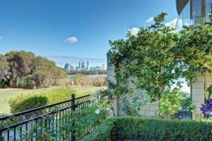 a house with a fence and a view of the city at River Suite Studio with Lovely Garden - Walk to River in Perth +7 photos