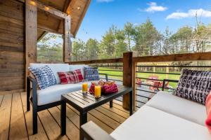 a patio with two couches and a table at Family fun, romantic Hot Tub, Firepit, King Bed 15 min from Blue Ridge & Ellijay in Blue Ridge