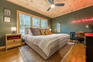 a bedroom with green walls and a bed and a desk at Family fun, romantic Hot Tub, Firepit, King Bed 15 min from Blue Ridge & Ellijay in Blue Ridge