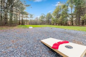 a book with a red bow sitting on top of a field at Family fun, romantic Hot Tub, Firepit, King Bed 15 min from Blue Ridge & Ellijay in Blue Ridge +34 photos
