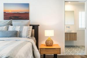 a bedroom with a bed and a table with a lamp at Sunhaven in North Creek