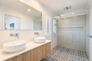 a bathroom with two sinks and a shower at Sunhaven in North Creek