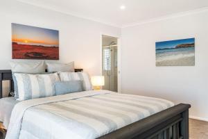 a white bedroom with a large bed in it at Sunhaven in North Creek +17 photos