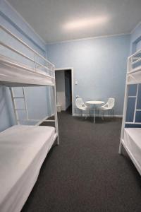 a room with two bunk beds and a table at Zen Hostel in Townsville +23 photos