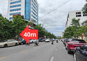 a group of people riding motorcycles down a city street at Vừng Hotel in Hue