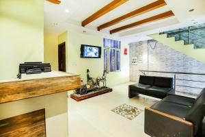 a living room with a couch and a table at Hotel O by OYO Angad Continental in Ambāla