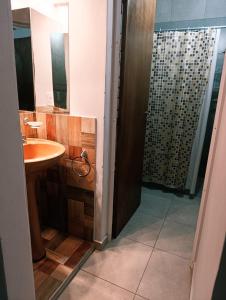 a bathroom with a sink and a shower at Complejo Bienteveo in San Antonio de Arredondo +20 photos