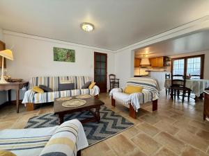 a living room with two couches and a table at Ordokia in Lasse