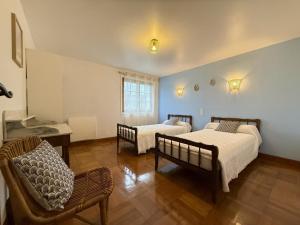 a room with two beds and a chair in it at Ordokia in Lasse