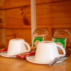 two cups of coffee on a table with milk at Maison Du Lac The Panoramic Glass Lodge in Wang Nam Khieo +8 photos