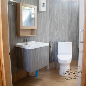 a bathroom with a sink and a toilet at Maison Du Lac The Panoramic Glass Lodge in Wang Nam Khieo
