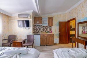 a room with a kitchen and a bedroom with two beds at suites beyazıt in Istanbul