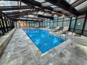 a large swimming pool in a building at Flat Hotel Executivo Ibirapuera Moema (Apto 844B) in São Paulo