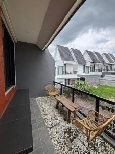 a balcony with a bench and some houses at Athara Residence in Tlekung