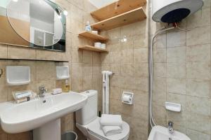 a bathroom with a sink and a toilet and a mirror at Studio Valleverde 26B - Happy Rentals in Sestriere