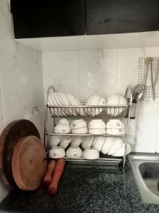 a kitchen counter with a rack of bowls and carrots at Thida Villa in Siem Reap +68 photos