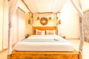 a bedroom with a white bed with a wooden headboard at Alaya Stays Luxe FarmAcre Pet-friendly 4-BHK Villa With Private Pool, Garden & Terrace in Gurgaon