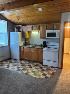 a kitchen with white appliances and a checkered floor at The Loft on the Lot in Cambridge