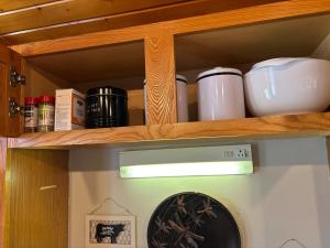 a shelf with dishes and other items on it at The Loft on the Lot in Cambridge +6 photos