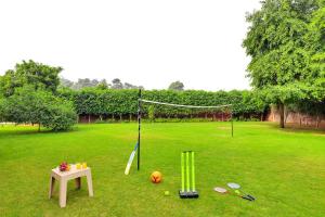a golf goal with a table and a ball at Alaya Stays Luxe FarmAcre Pet-friendly 4-BHK Villa With Private Pool, Garden & Terrace in Gurgaon +56 photos
