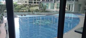 a view of a swimming pool from a window at Knightsbridge Residences with Free Pool, Sauna, Fast WiFi, Gym and Kitchen in Manila