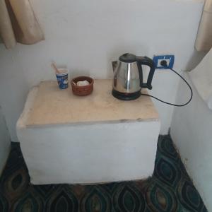 a tea kettle sitting on a counter in a room at Asilah kato nubian guest house in Aswan
