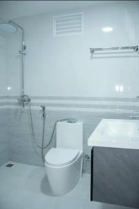 a white bathroom with a toilet and a sink at Sunset Private Villa in Bandara +34 photos