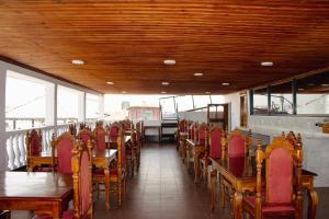 a dining room with wooden tables and chairs at Shangani Hotel in Zanzibar City