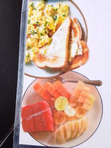 two plates of breakfast food with toast and fruit at SKY SUNSET Bungalows in Tetebatu +35 photos